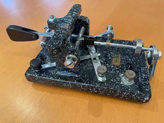 1940 McElroy 600 Bug with a black painted base and white speckled paint creating a faux-marble look that McElroy called "Marbelite".  Note the paddles are not original. This bug came from the estate of an SK from Dayton, OH in the early 2000's.  BTW a hidden feature of all Mac Bugs is the if you flip them on their side you can use them as a straight key.