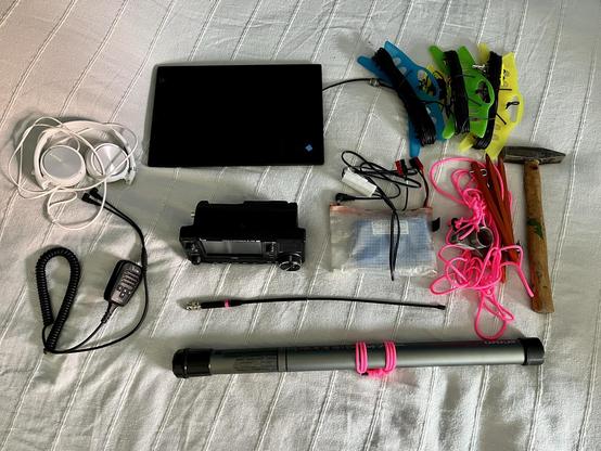 Portable loadout neatly arranged. Icom IC-705, with antenna, mast, battery pack and computer